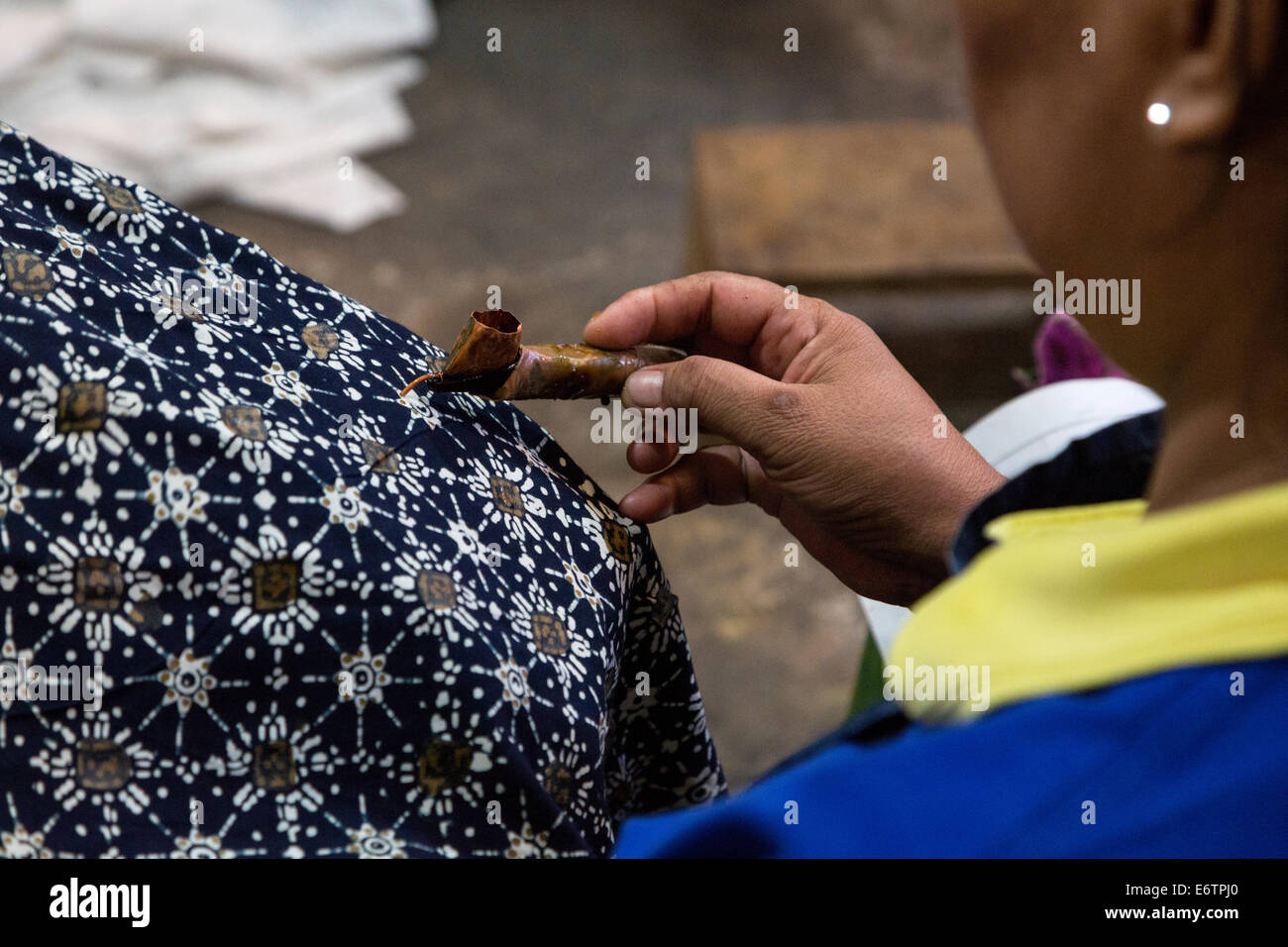 Yogyakarta, Java, Indonesia.  Batik Workshop.  Female Worker Applying Wax to Batik Design. Stock Photo