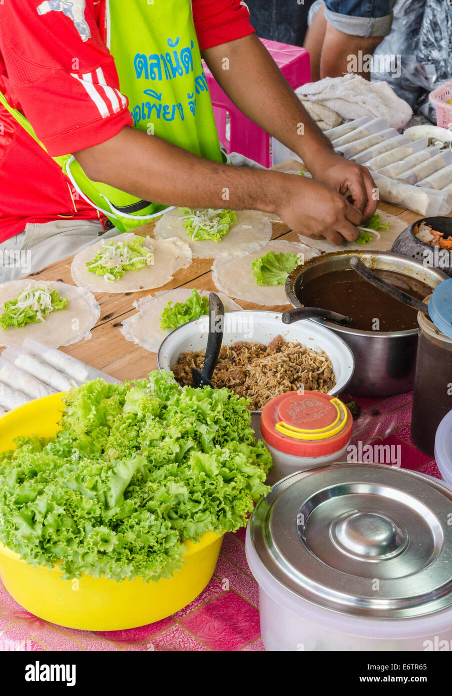 Man making Thai spring rolls in the Kata Fresh Market in Kata, Phuket, Thailand Stock Photo