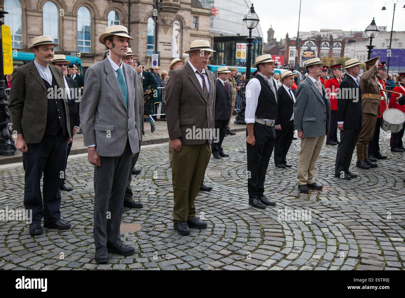 Liverpool, Merseyside, UK 31st August, 2014. Civilian volunteers in their famous straw boaters, enlist, join, recruit, man, enlistment, recruitment, symbol, uniform, white, isolated, recruiting, icon, soldier, business, military, enroll, & waiting to enlist as Prince Edward visits The Liverpool Pals commemoration and the re-enactment of the Liverpool Pals signing up to answer Lord Derby's call for recruits 100 years to the day it happened. Liverpool's success prompted other towns to form units, with civic pride and community spirit driving a competition to raise the highest numbers. Stock Photo