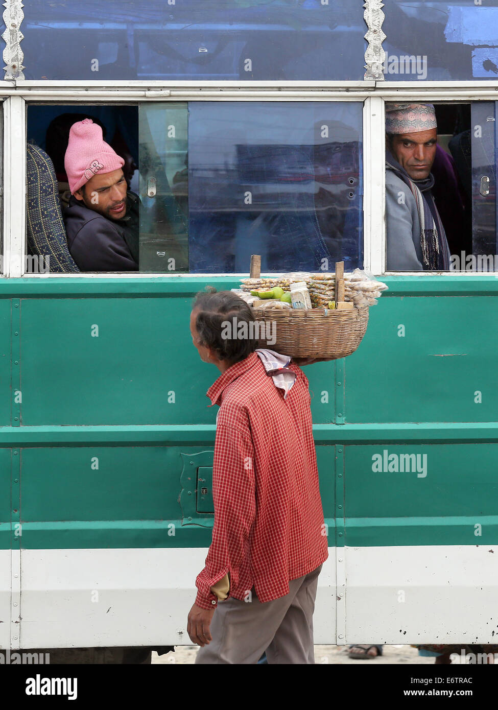 Street seller sells snacks to passengers on local buses in Damak, Nepal Stock Photo