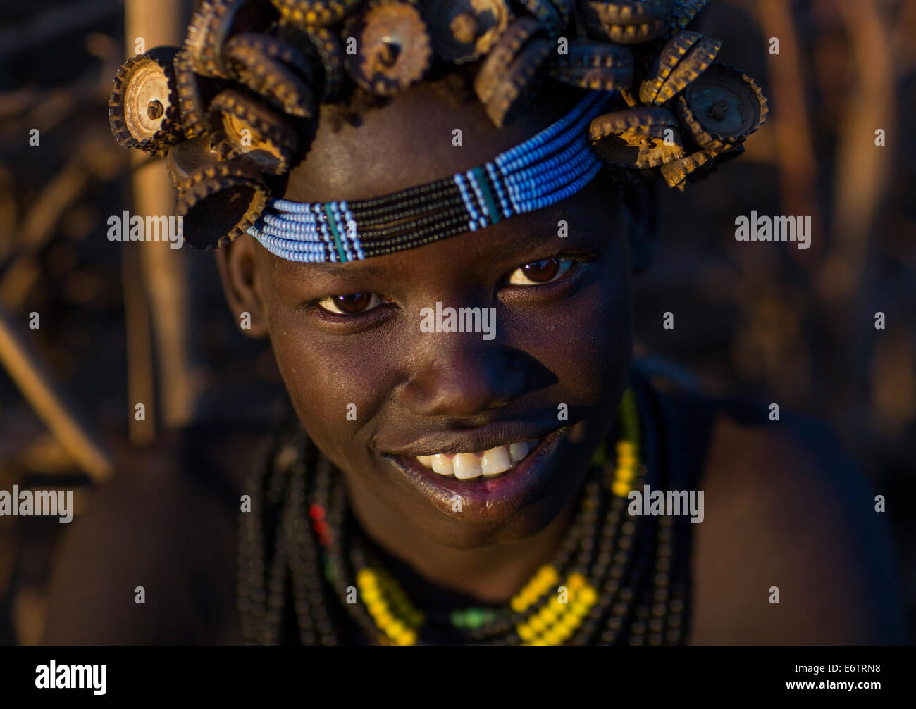 Portrait Of A Young Dassanech Girl Wearing Bottle Caps Headgear And Beaded Necklaces, Omorate, Omo Valley, Ethiopia Stock Photo