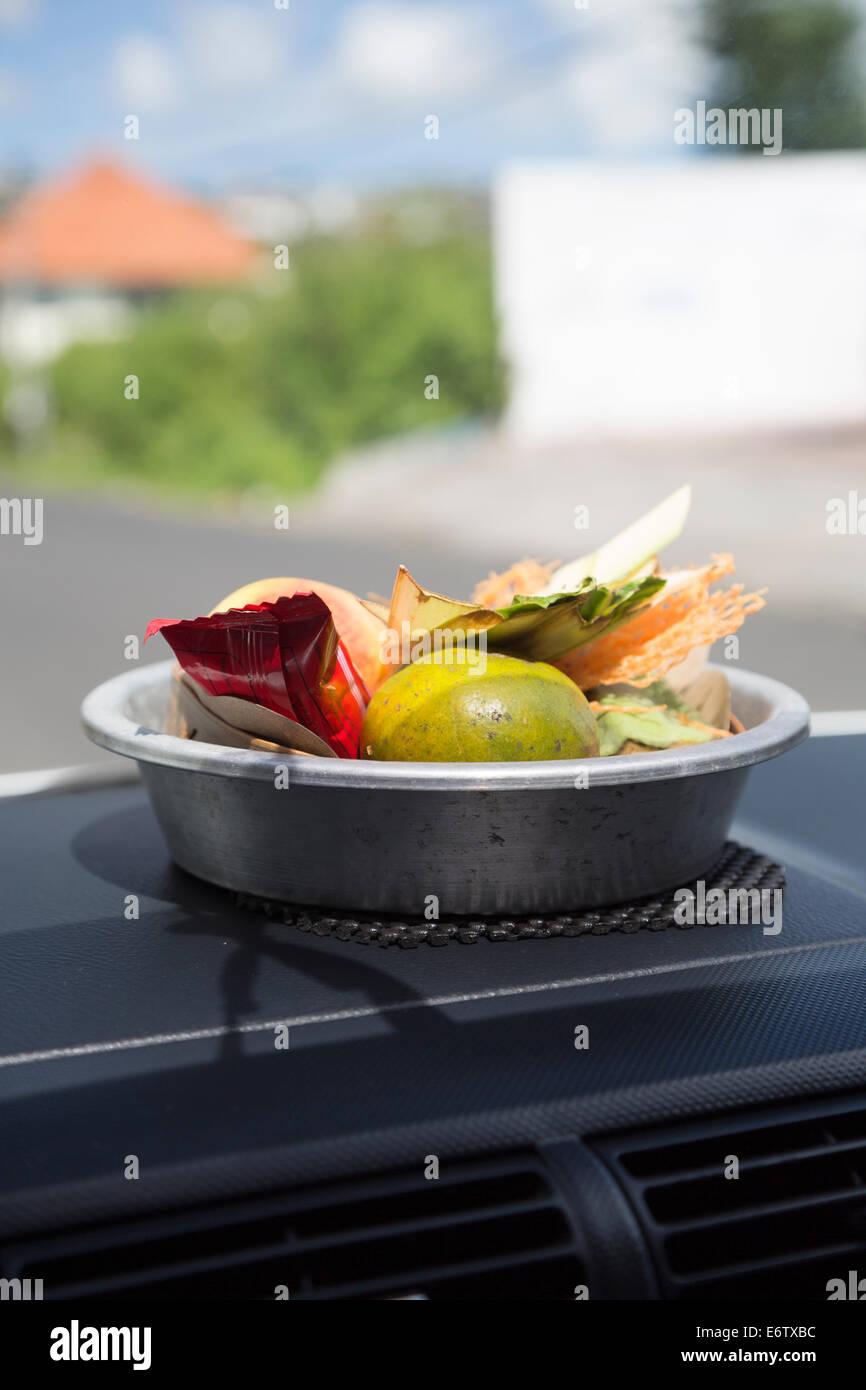 Bali, Indonesia.  A Canang, a Balinese Offering to the Gods, on the Dashboard of a Private Car. Stock Photo