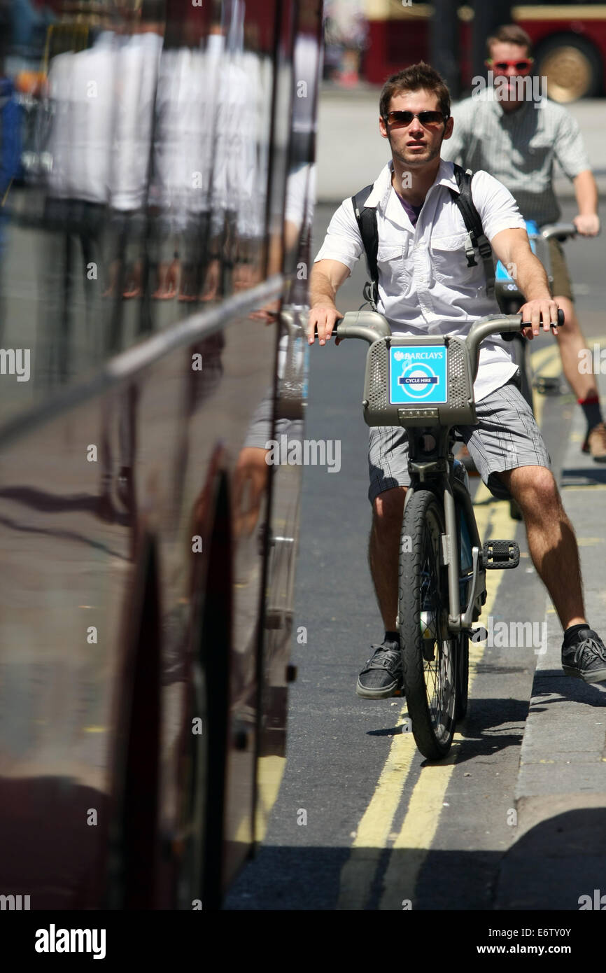 Two cyclists behind a stationary London bus Stock Photo - Alamy