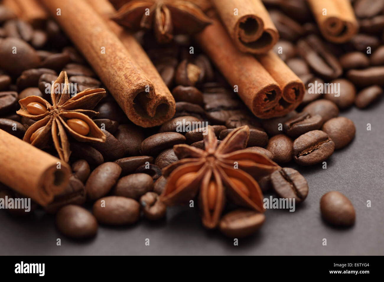 Cinnamon sticks, star anise and coffee beans. Black background. Close-up. Stock Photo