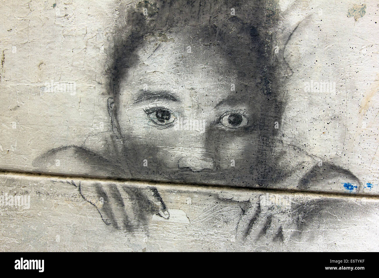 Graffiti of a kid in hiding looking at you in a wall of Panama City. Stock Photo