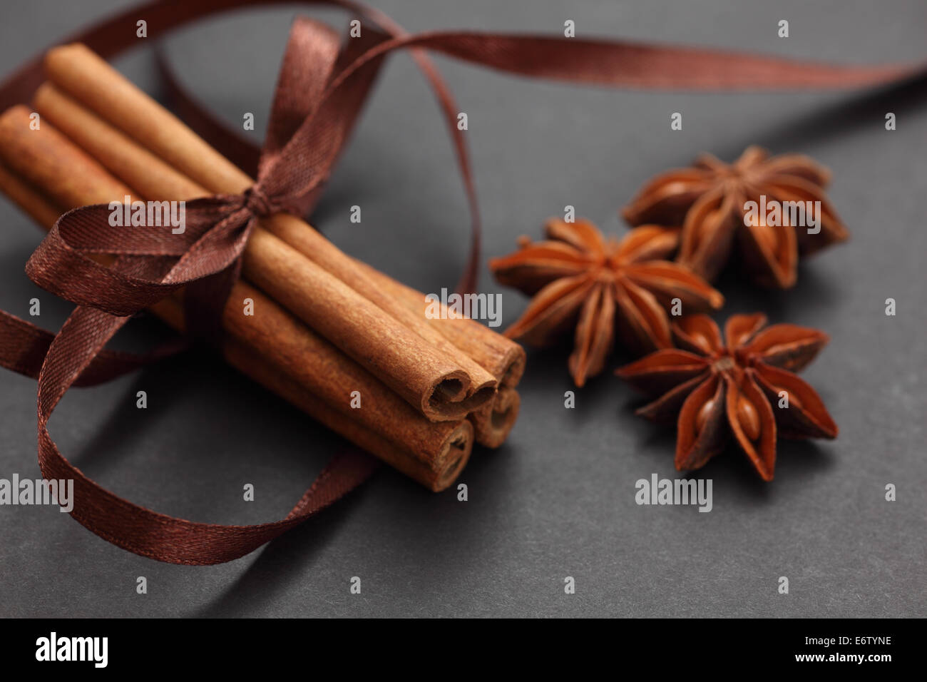 Cinnamon sticks and star anise. Black background. Close-up. Stock Photo