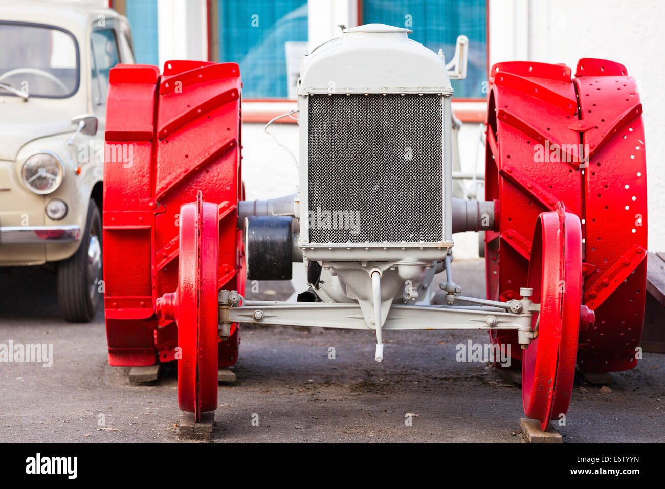 Front view of old white tractor with red wheels Stock Photo
