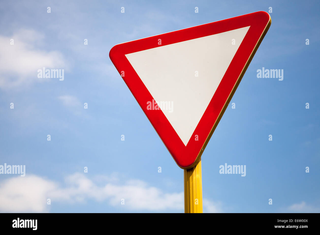 Give way road sign above cloudy sky Stock Photo