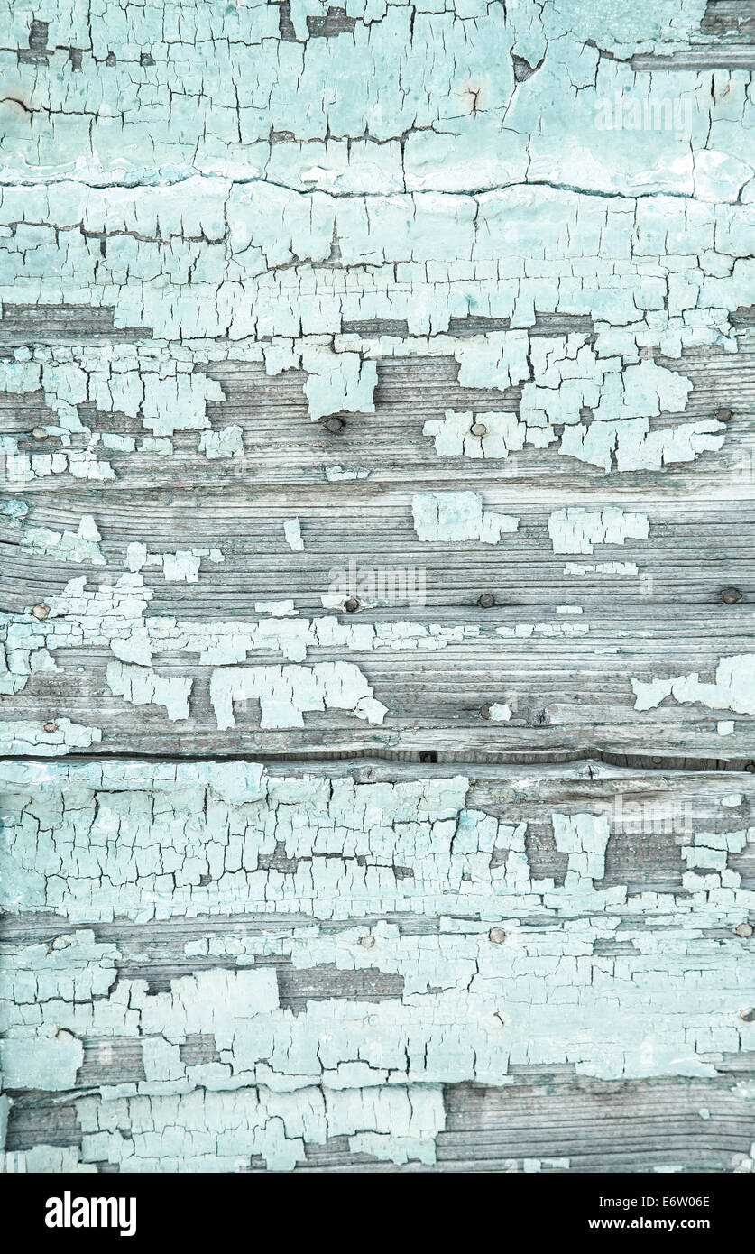 Old rustic background with peeled colour and cracks in mint green color. Stock Photo