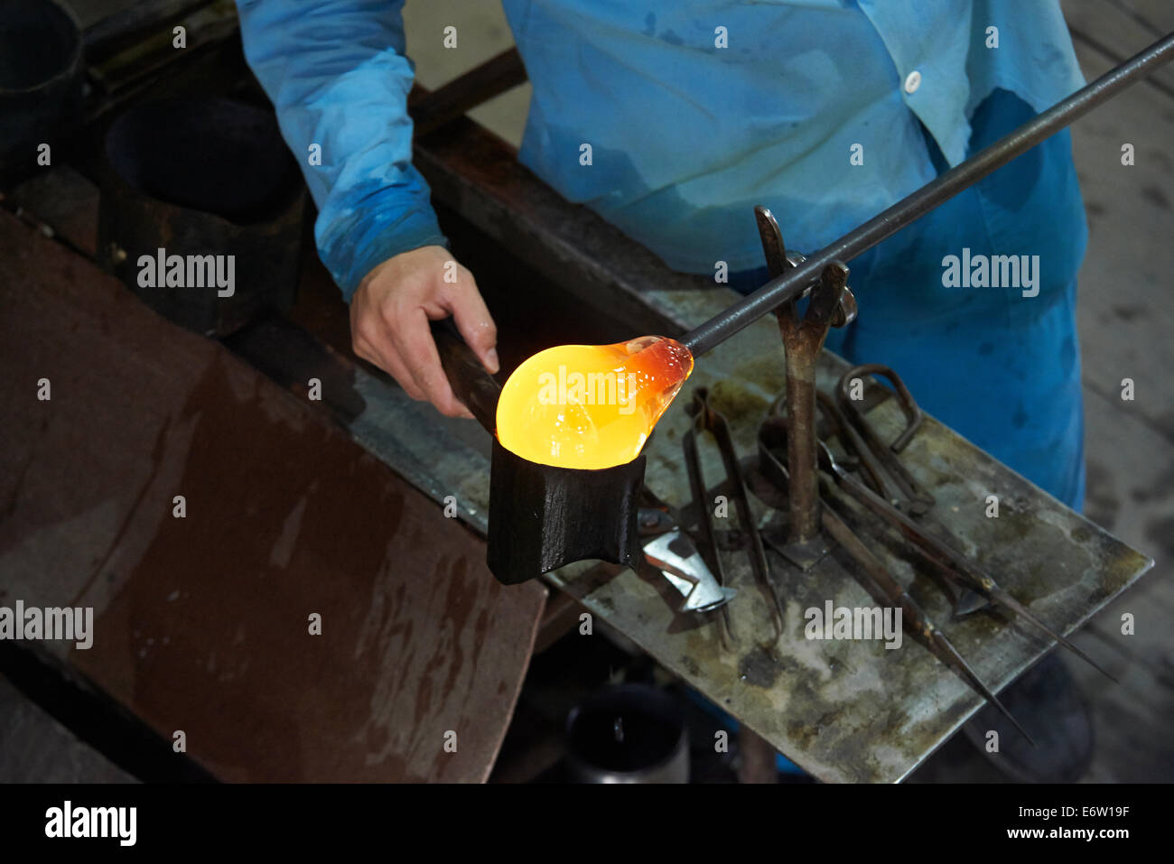 Glassmakers, Glassblowers forming molten glass, glass factory, Ajeto