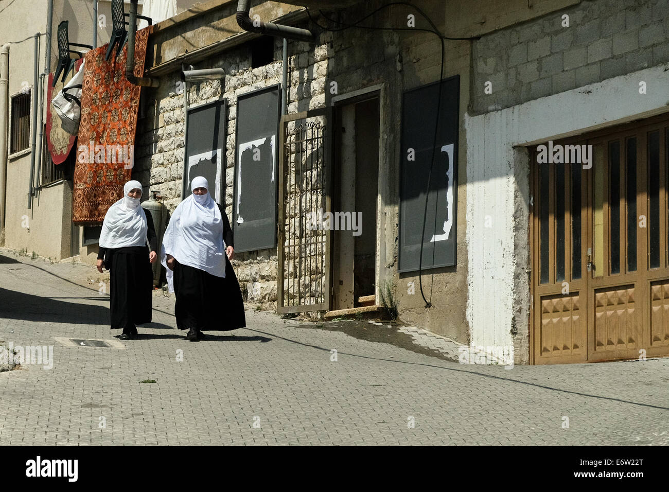Golan Heights, Israel. 31st Aug, 2014. Druze women walk down a street in the city of Majdal Shams in the Golan Heights, home to a population of over 10,000. Since the beginning of the Syrian revolt Israel is seeing an increase in Druze residents requesting Israeli citizenship, now more willing to openly admit their appreciation of Israel's liberal democracy and less weary of Syrian retribution. Credit:  Nir Alon/Alamy Live News Stock Photo