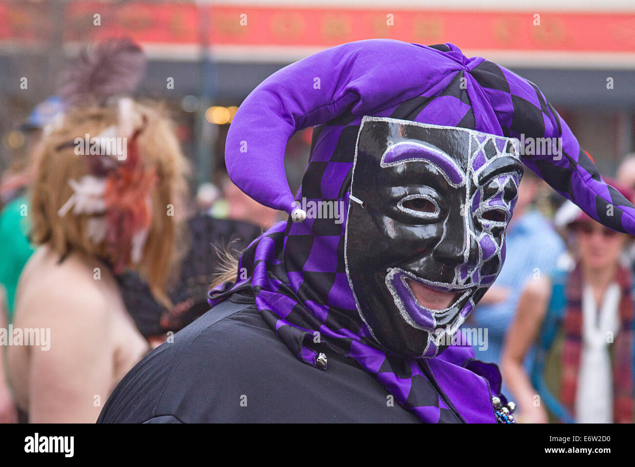 Asheville, North Carolina, USA: March 2, 2014: Close up of a man in a sinister looking, colorful, black and purple mask and cost Stock Photo