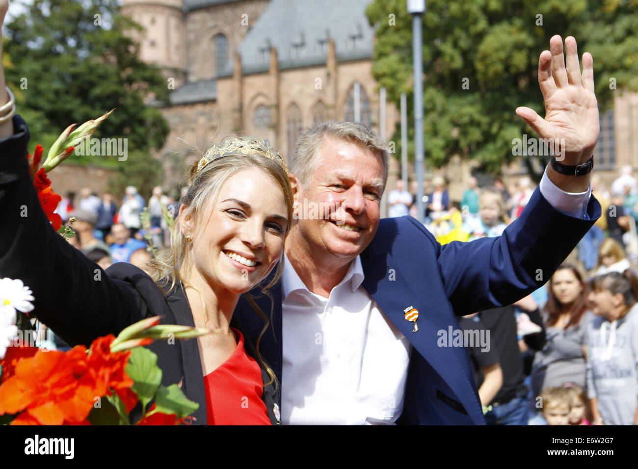 Worms, Germany. 31st August 2014. The Rhine-Hessian wine queen, Judith Dorst (left), and the Lord Mayor of Worms, Michael Kissel (right), wave at the crowd. The first highlight of this year's Backfischfest was the big parade through the city of Worms with 125 groups and floats. Community groups, sport clubs, music groups and business from Worms and further afield took part. Credit:  Michael Debets/Alamy Live News Stock Photo