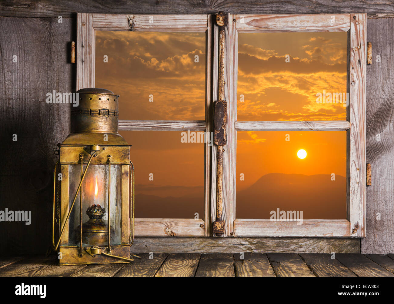 Old copper lantern on Windows sill: view outdoor when the sun rise up. Concept for dreams, feelings or mourning. Stock Photo