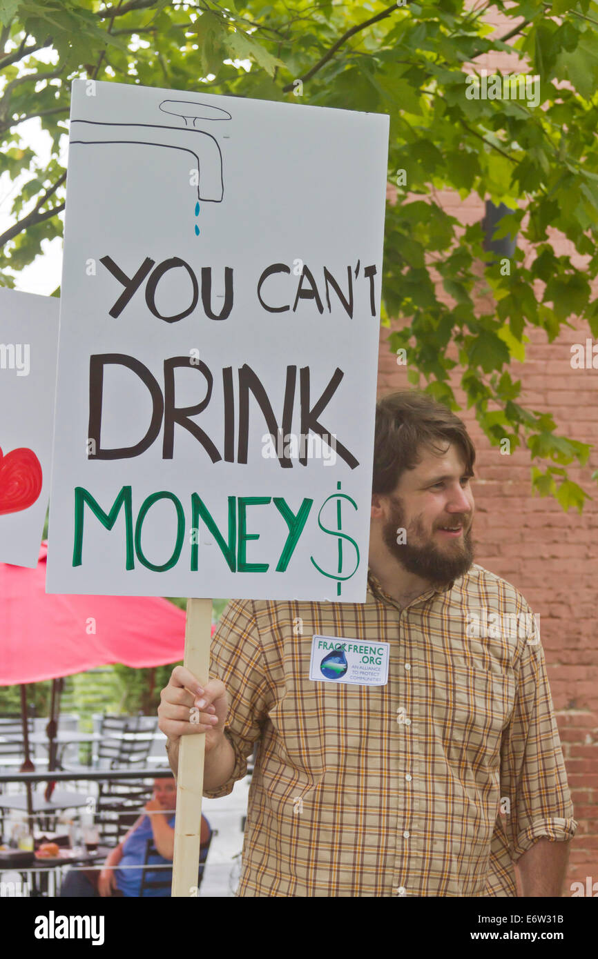 Man at a Moral Monday rally holds a sign protesting fracking in downtown Asheville, NC Stock Photo