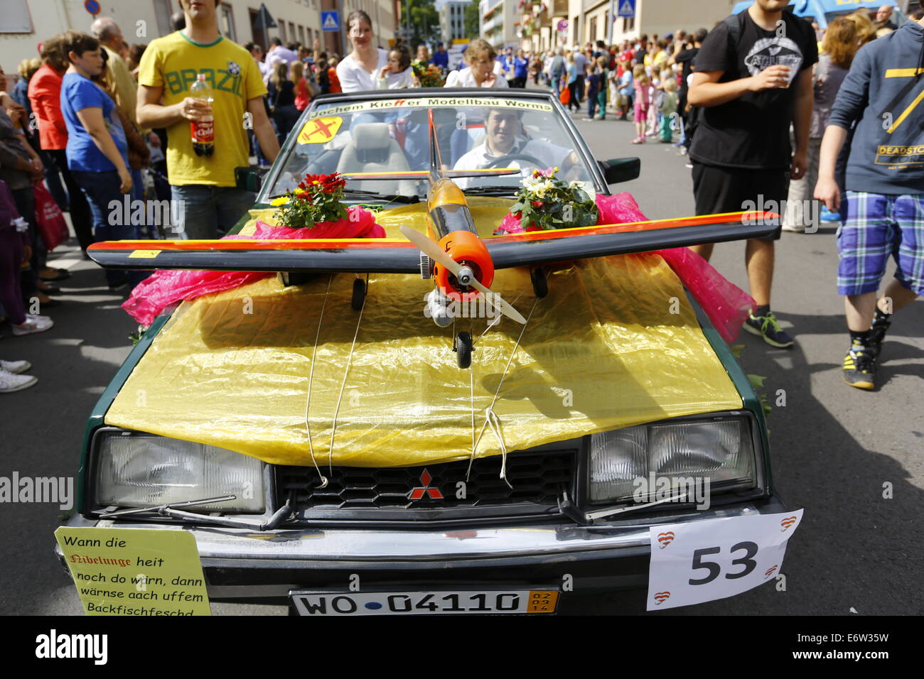 Worms, Germany. 31st August 2014. A model airplane is pictured on the bonnet of a car during the Backfischfest parade 2014.  The first highlight of this year's Backfischfest was the big parade through the city of Worms with 125 groups and floats. Community groups, sport clubs, music groups and business from Worms and further afield took part. Credit:  Michael Debets/Alamy Live News Stock Photo