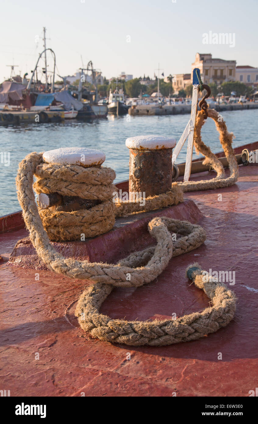 In the port: Old sisal rope of an ancient ship fixed on the docks in the harbor. Stock Photo