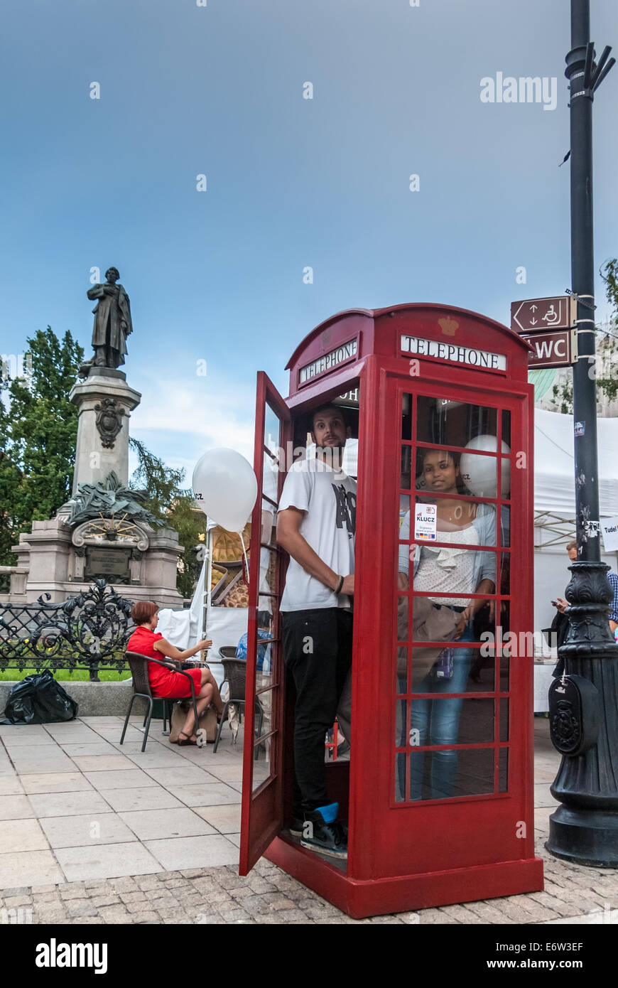 BT Red Telephone Box and Monument to Adam Mickiewicz, Warsaw, Poland Stock Photo