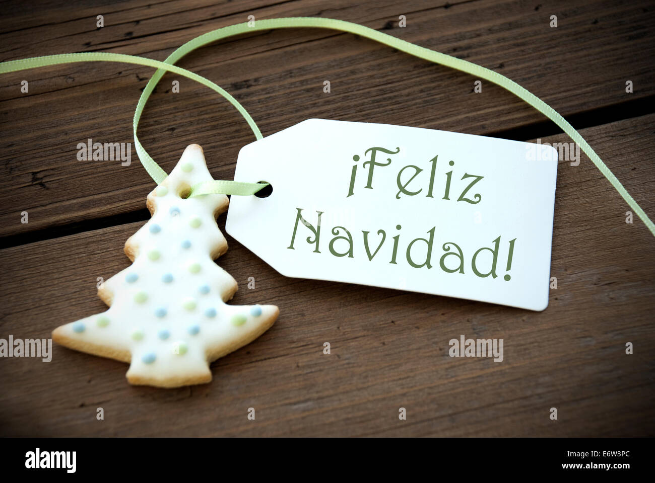 A Christmas Tree Cookie with a Label with the Spanish Words Feliz Navidad on it which means Merry Christmas Stock Photo