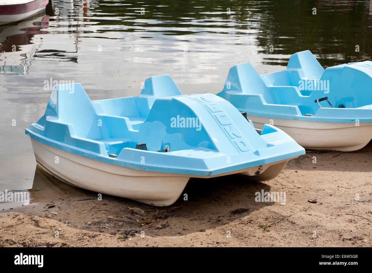 Blue paddle boat waiting on beach Stock Photo Alamy