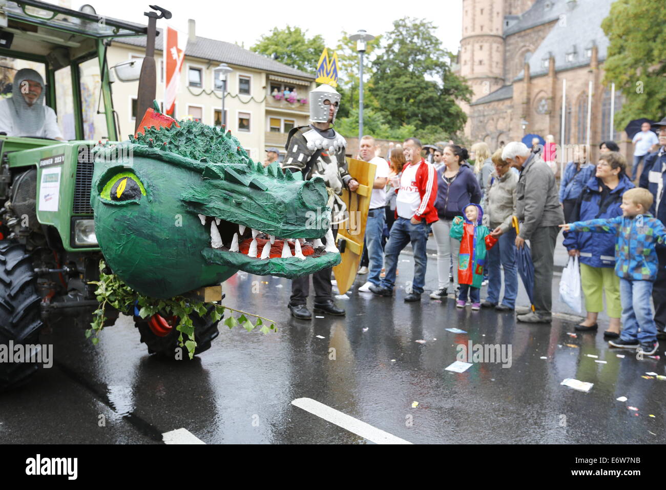 Worms, Germany. 31st Aug, 2014. A float with a dragon head is pictured at the Backfischfest parade 2014. The cathedral of Worms can be seen in the background. The first highlight of this year's Backfischfest was the big parade through the city of Worms with 125 groups and floats. Community groups, sport clubs, music groups and business from Worms and further afield took part. © Michael Debets/Pacific Press/Alamy Live News Stock Photo