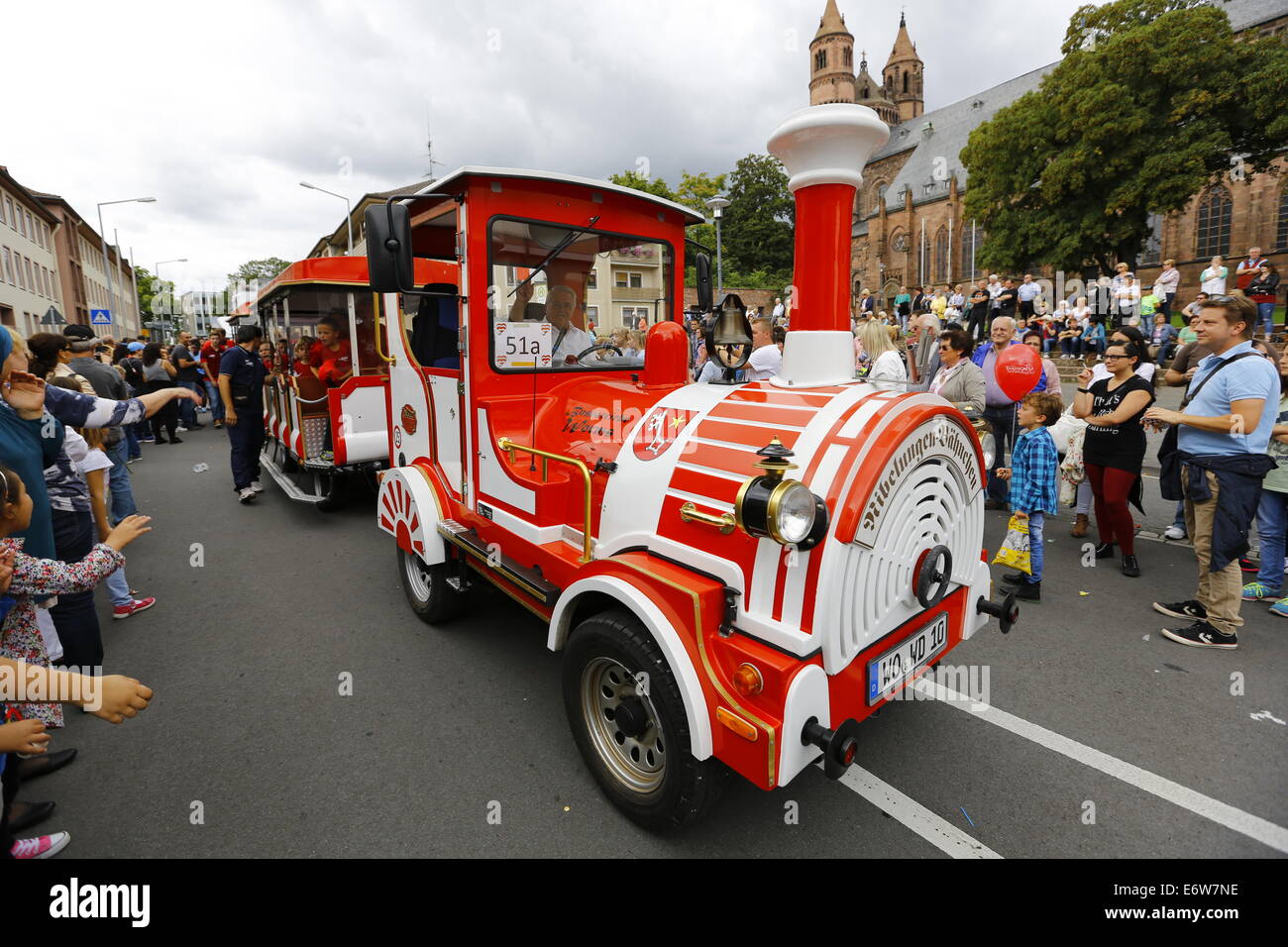 Worms, Germany. 31st Aug, 2014. The Nibelungen Bähnchen (Nibelungs little train) is pictured at the Backfischfest parade 2014. The cathedral of Worms can be seen in the background. The first highlight of this year's Backfischfest was the big parade through the city of Worms with 125 groups and floats. Community groups, sport clubs, music groups and business from Worms and further afield took part. © Michael Debets/Pacific Press/Alamy Live News Stock Photo