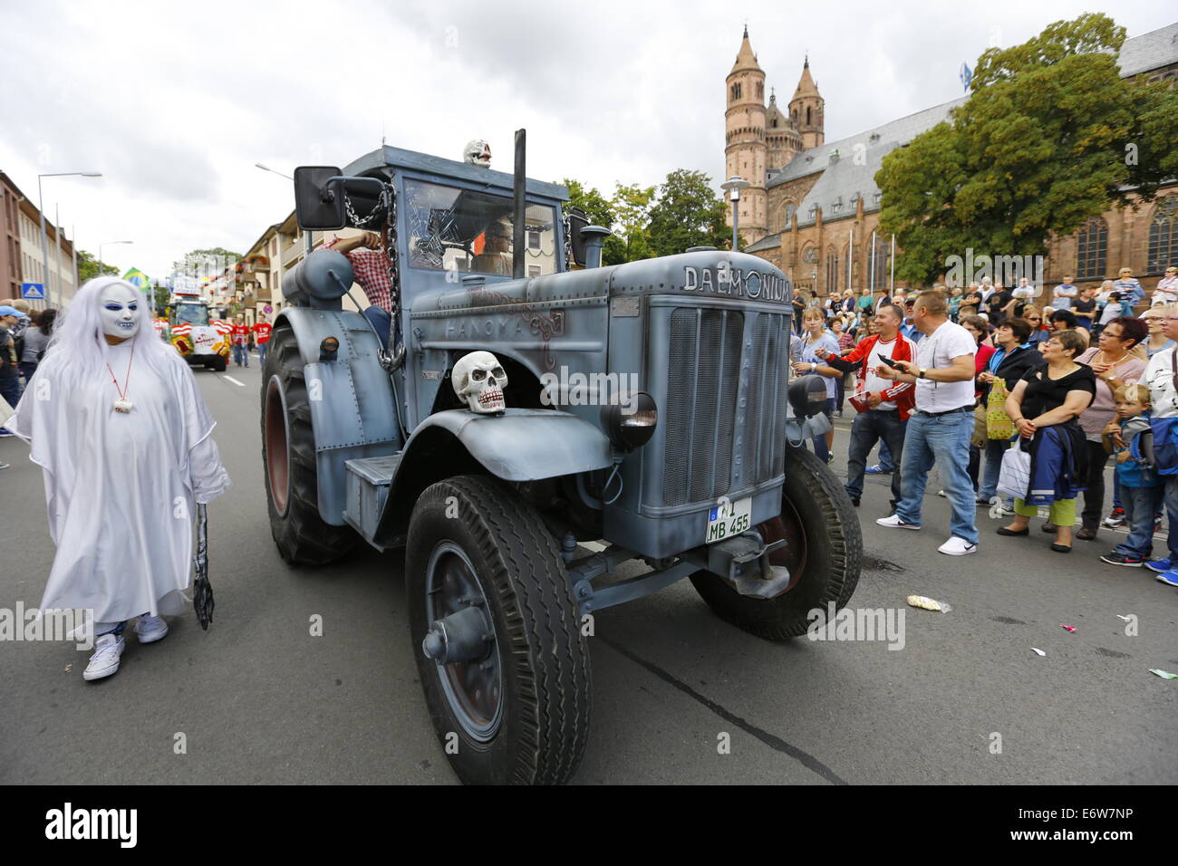 Worms, Germany. 31st Aug, 2014. A tractor, decorated in a ghost an demon theme, is pictured in the Backfischfest parade 2014. The cathedral of Worms can be seen in the background. The first highlight of this year's Backfischfest was the big parade through the city of Worms with 125 groups and floats. Community groups, sport clubs, music groups and business from Worms and further afield took part. © Michael Debets/Pacific Press/Alamy Live News Stock Photo