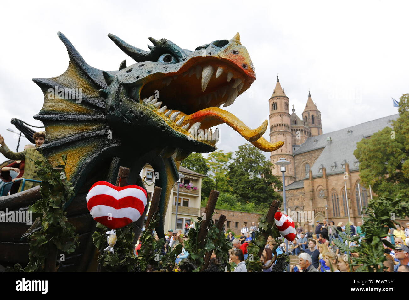 Worms, Germany. 31st Aug, 2014. A float with a dragon, a symbol of the city of Worms, is pictured at the Backfischfest parade 2014. The cathedral of Worms can be seen in the background. The first highlight of this year's Backfischfest was the big parade through the city of Worms with 125 groups and floats. Community groups, sport clubs, music groups and business from Worms and further afield took part. © Michael Debets/Pacific Press/Alamy Live News Stock Photo