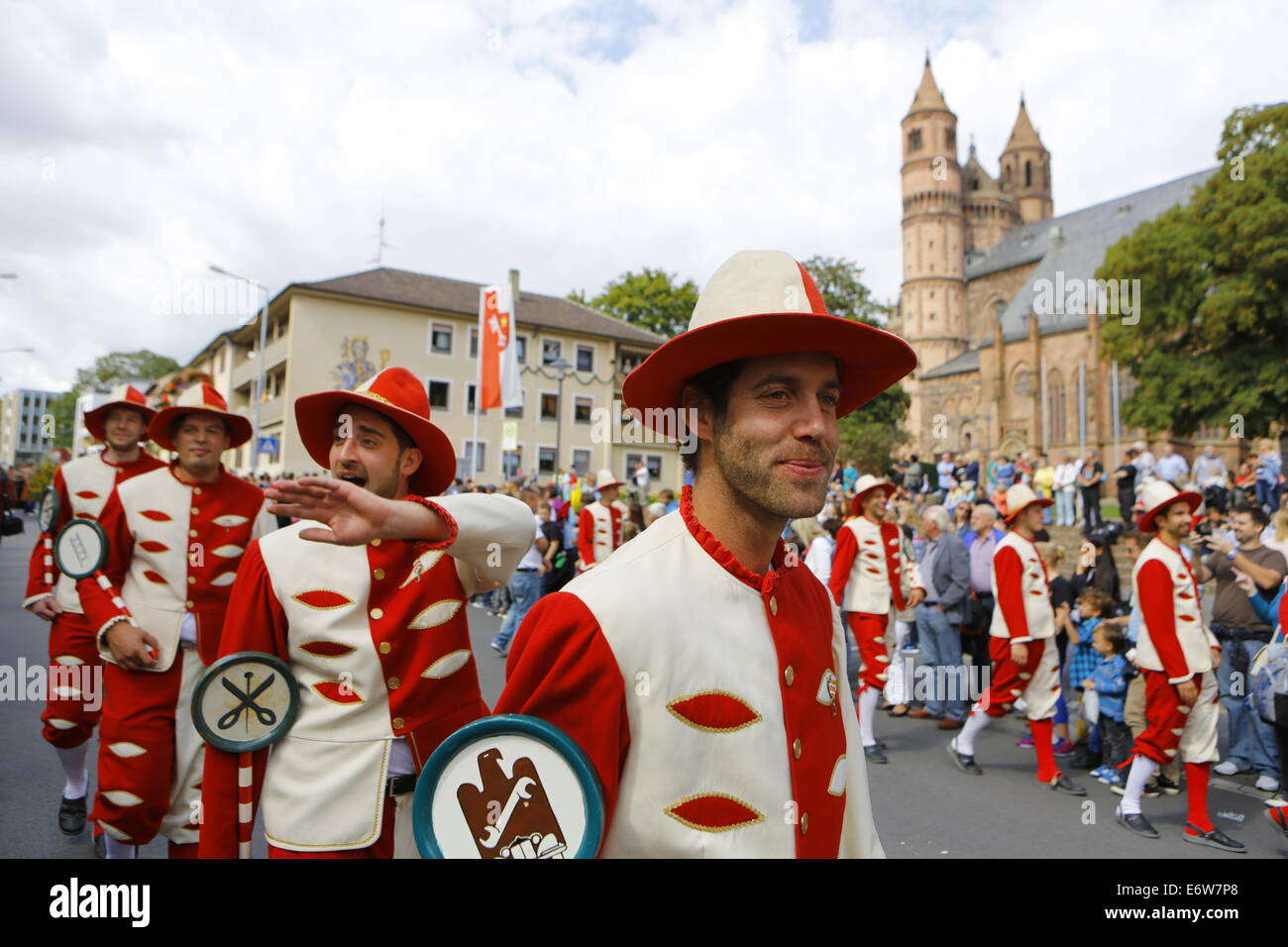 Worms, Germany. 31st Aug, 2014. Journeymen in historical uniforms march in the Backfischfest parade 2014. The cathedral of Worms can be seen in the background. The first highlight of this year's Backfischfest was the big parade through the city of Worms with 125 groups and floats. Community groups, sport clubs, music groups and business from Worms and further afield took part. © Michael Debets/Pacific Press/Alamy Live News Stock Photo