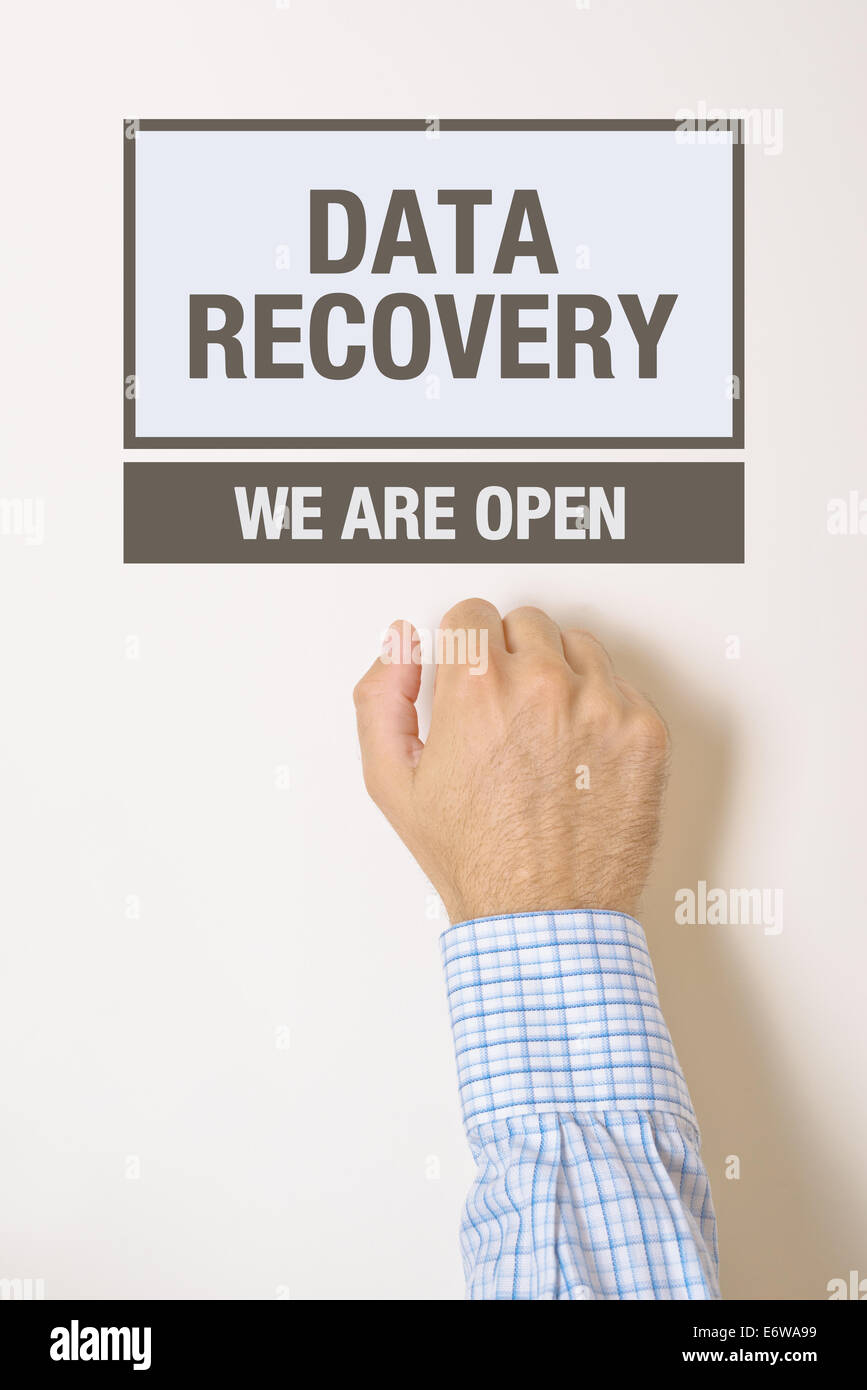 Businessman knocking on Data Recovery Office door looking for a help service Stock Photo