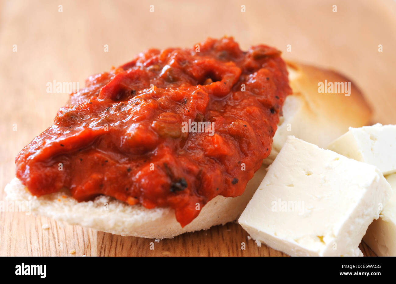 Delicious Bulgarian chutney with a bread and cheese. Stock Photo