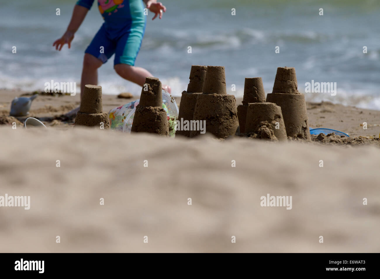 A child plays on Swanage beach. Stock Photo