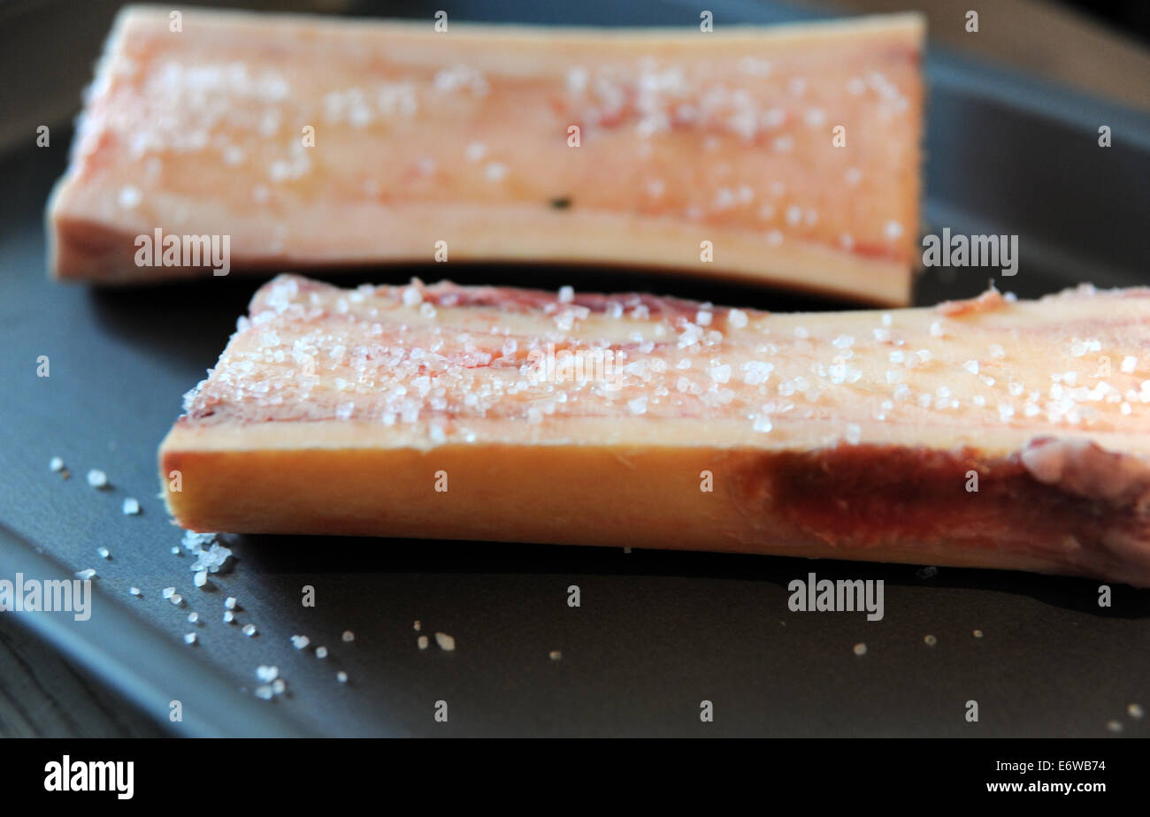 Beef bone marrow sprinkled with sea salt ready for roasting cooking