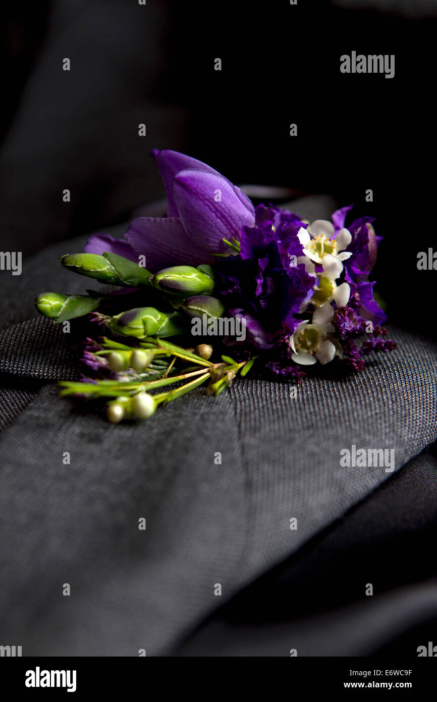 A groom's floral buttonhole on their wedding day. Stock Photo