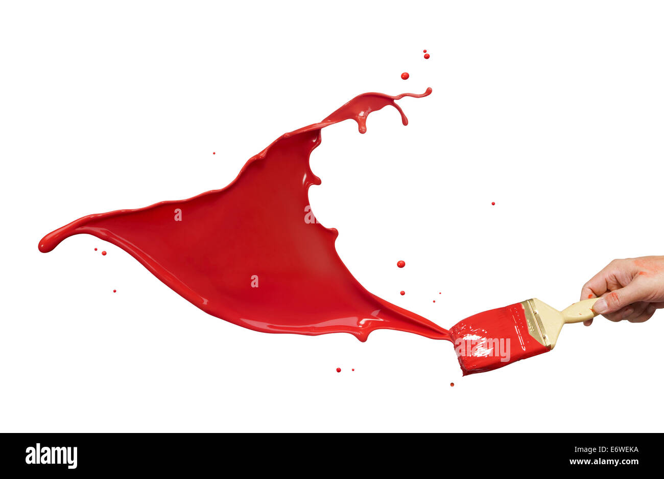 hand holding paintbrush creating red paint splash Stock Photo