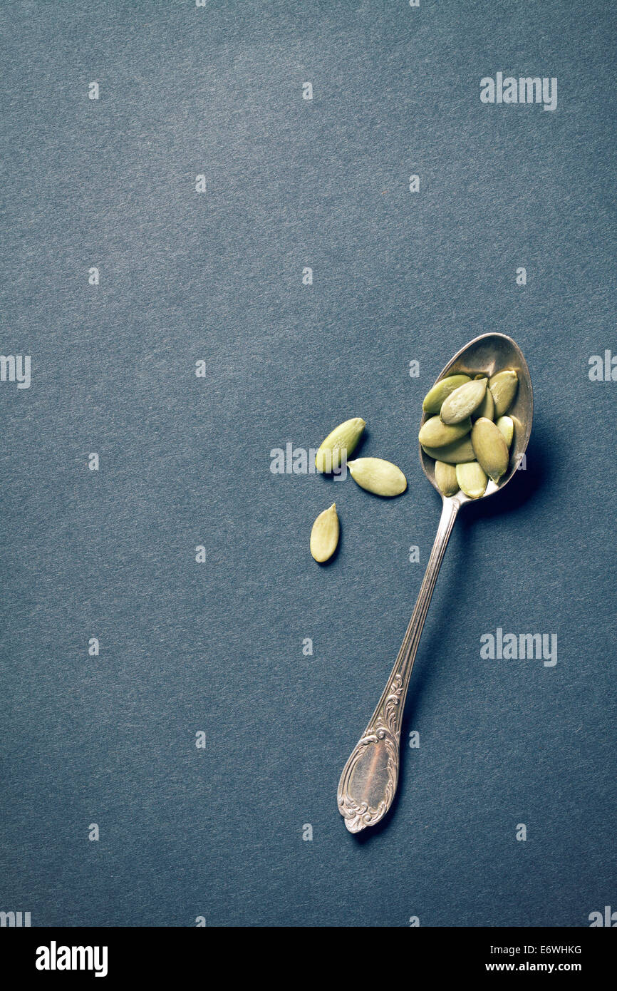 top view of pumpkin seeds in silver spoon Stock Photo