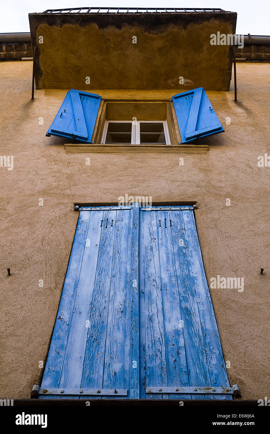 An old facade building with blue colorful windows Stock Photo - Alamy