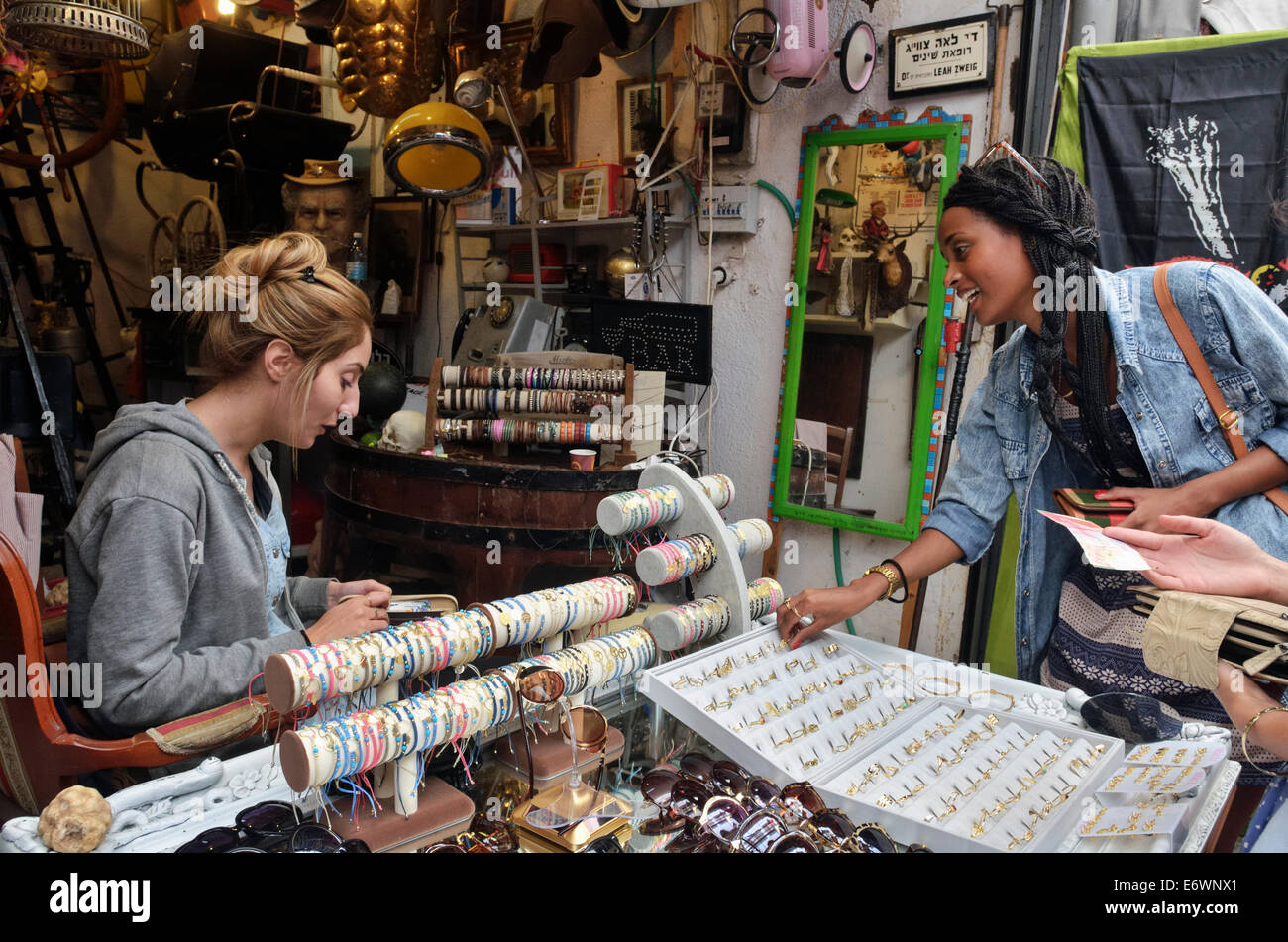 Girls buying jewellery in antique shop, Jaffa flea market, Israel Stock