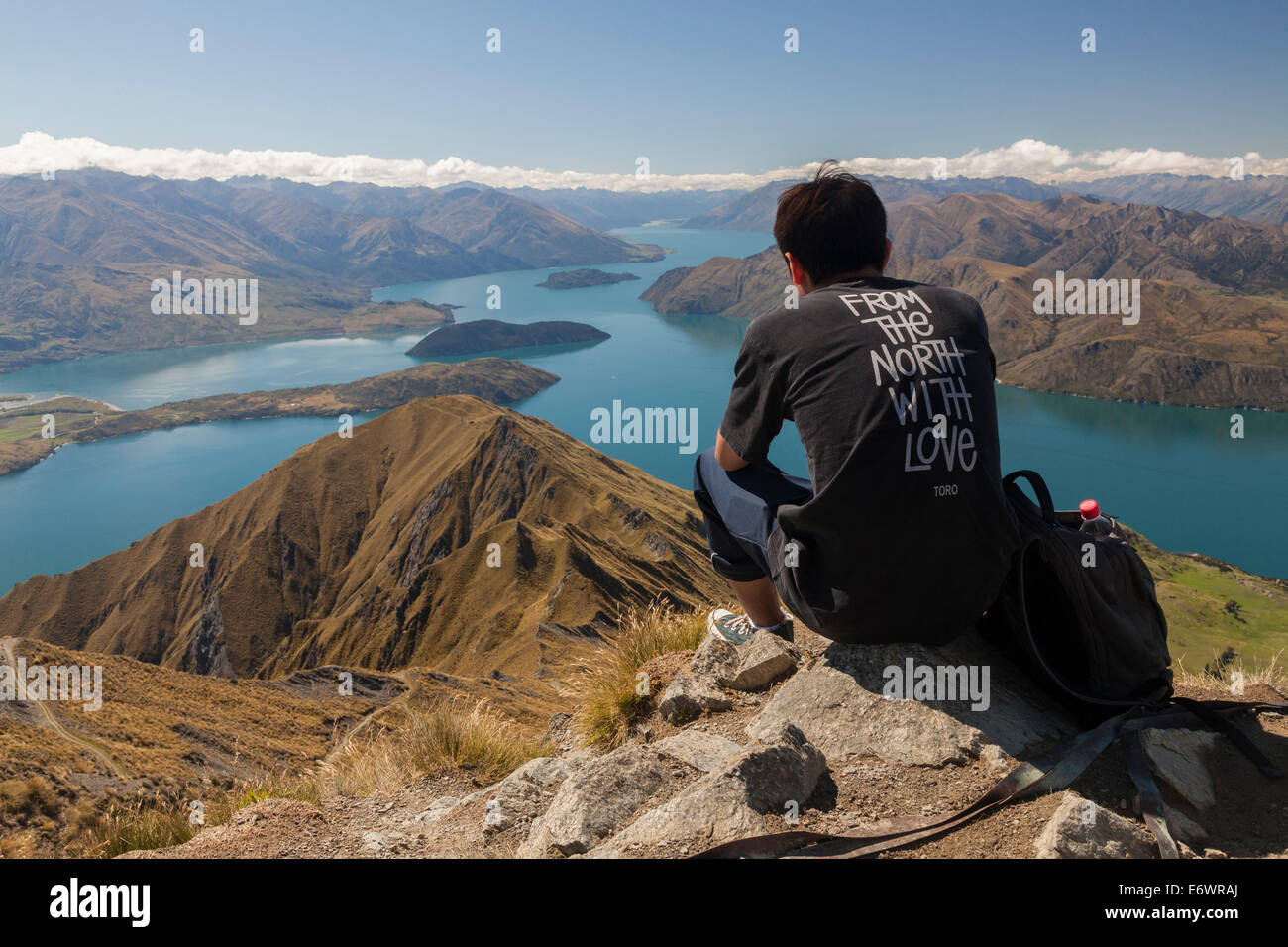 Hiker enjoying the views from Mt Roy over Lake Wanaka, South Island, New Zealand Stock Photo