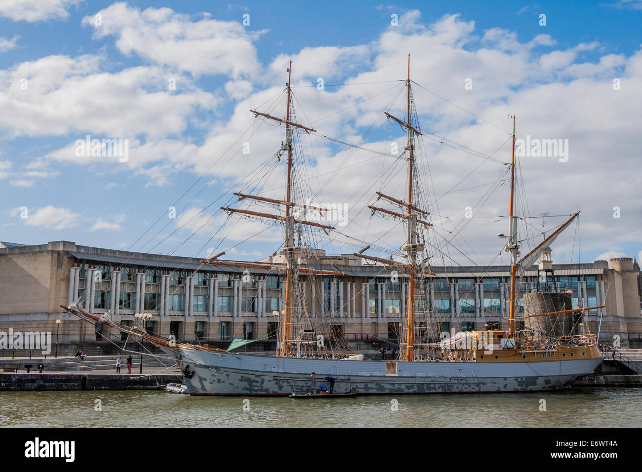 A tall ship gets repaired on a mooring outside a huge office of Lloyds Bank in Bristol Docks Stock Photo