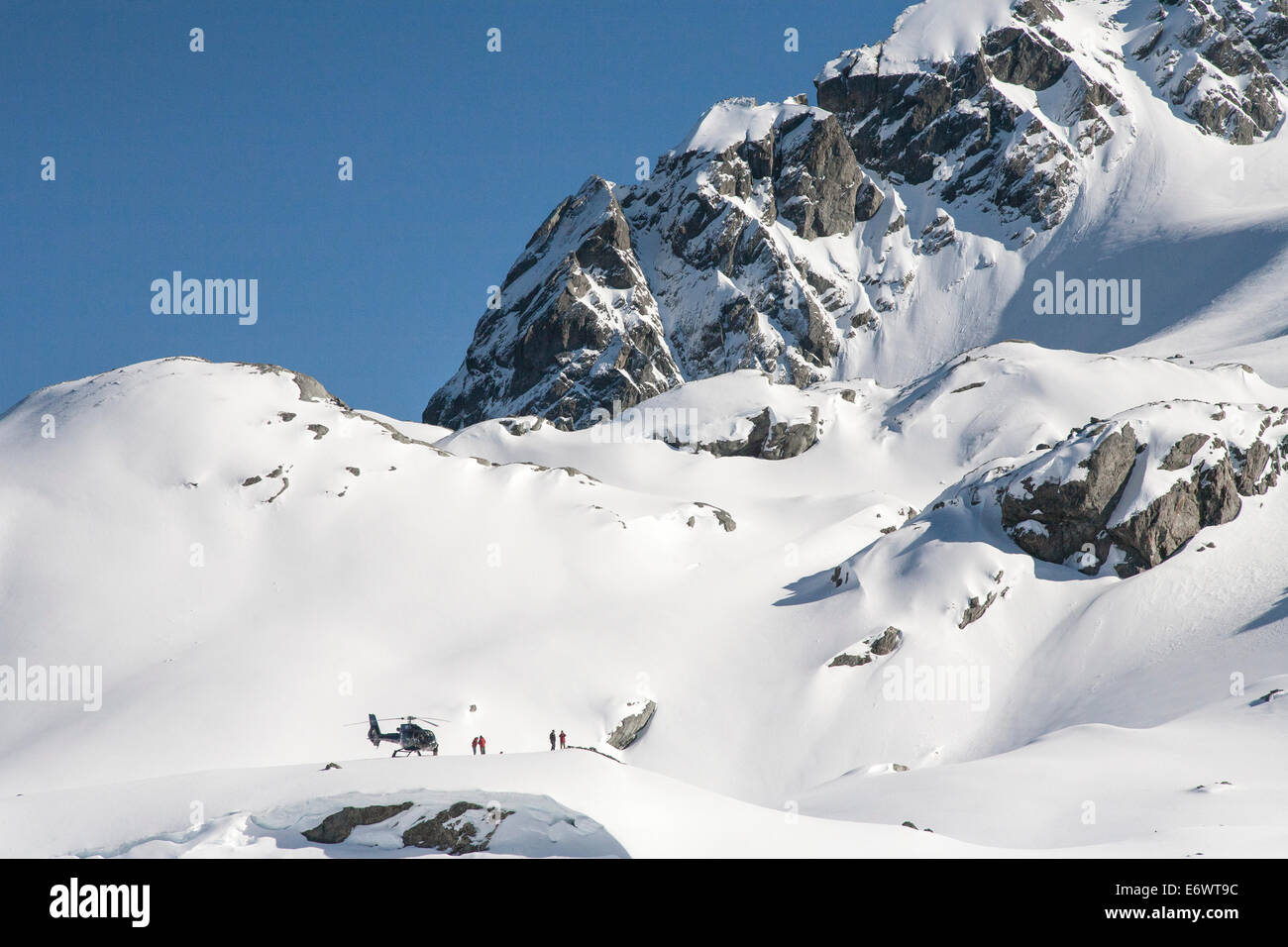 Helicopter landing on the mountain top with winter sportsmen, Heliskiing, South Island, New Zealand Stock Photo