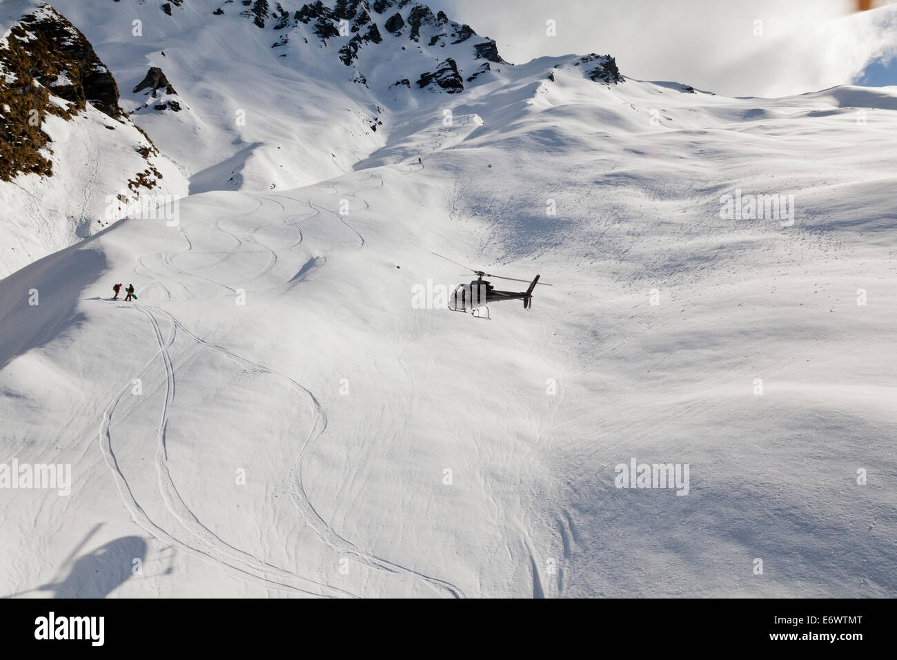 Helicopter landing with winter sportsmen, Skiers and snowboarders, Queenstown, South Island, New Zealand Stock Photo