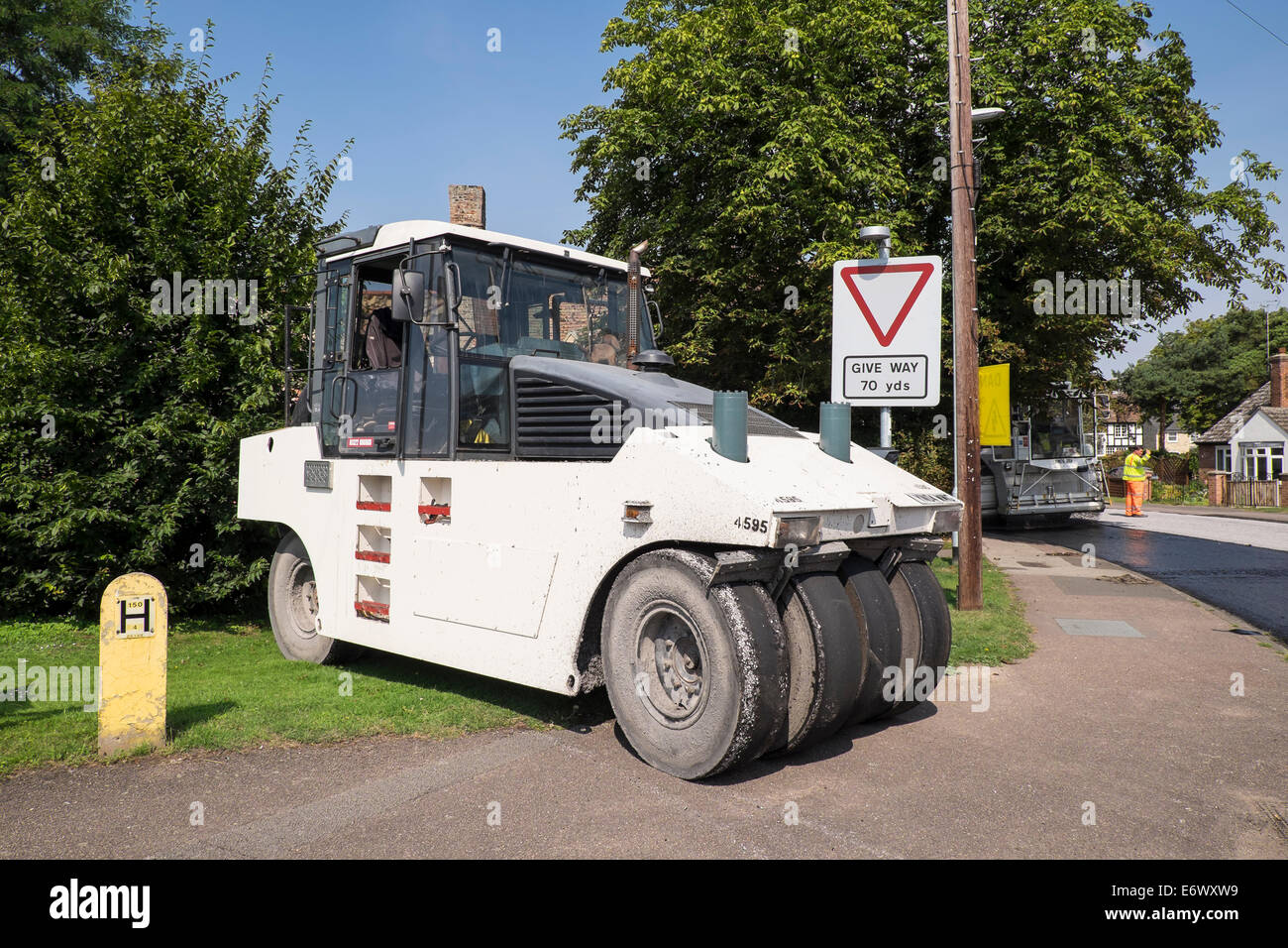 Road roller for compaction of granite chippings into hot tar during road resurfacing Fen Road Milton Stock Photo