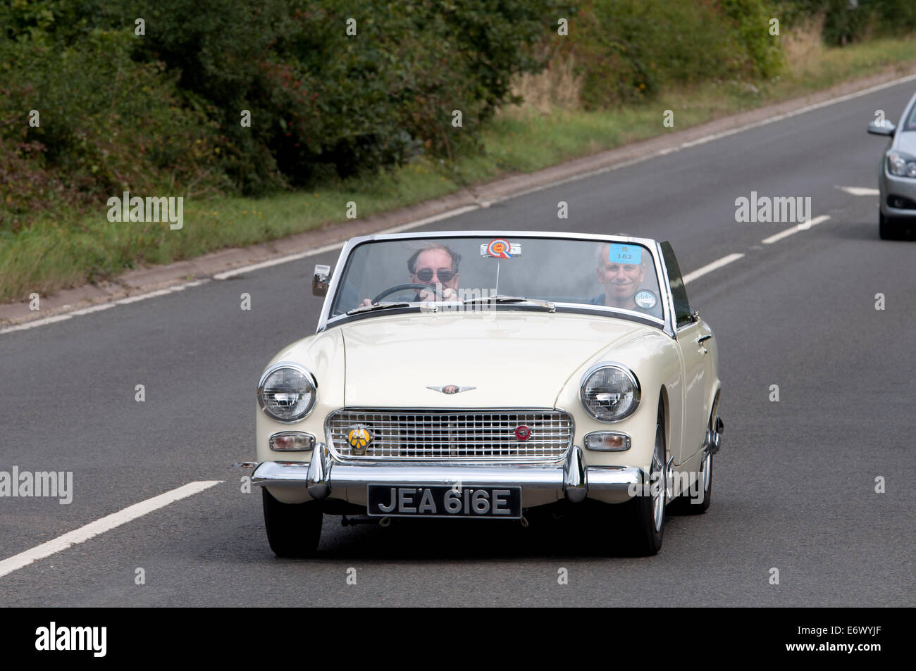 Austin Healey Sprite car on the Fosse Way road, Warwickshire, UK Stock Photo