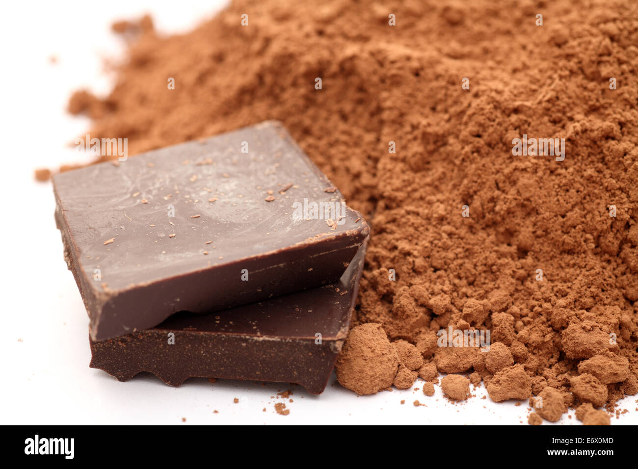 Chocolate and heap of cocoa powder. Closeup. Stock Photo