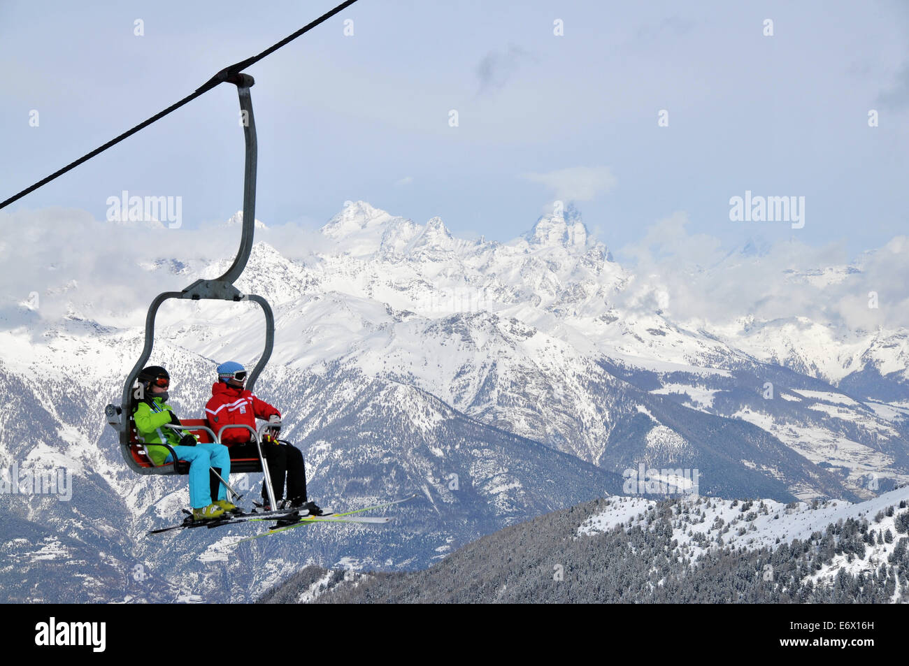 Two people in a ski lift, Pila ski resort, Aosta with Matterhorn, Aosta Valley, Italy Stock Photo
