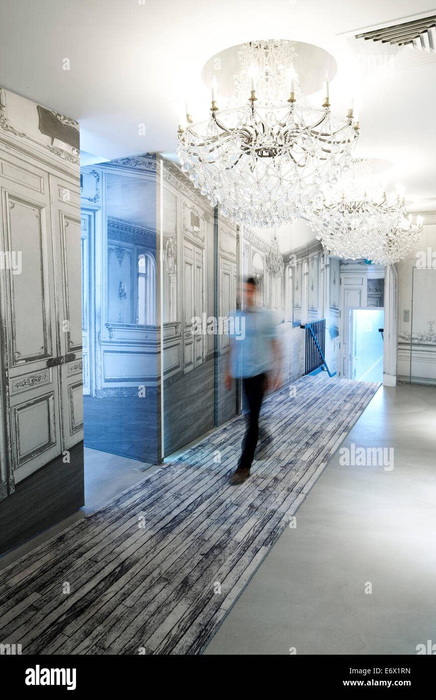 Man walking along a hotel corridor, Paris, France Stock Photo