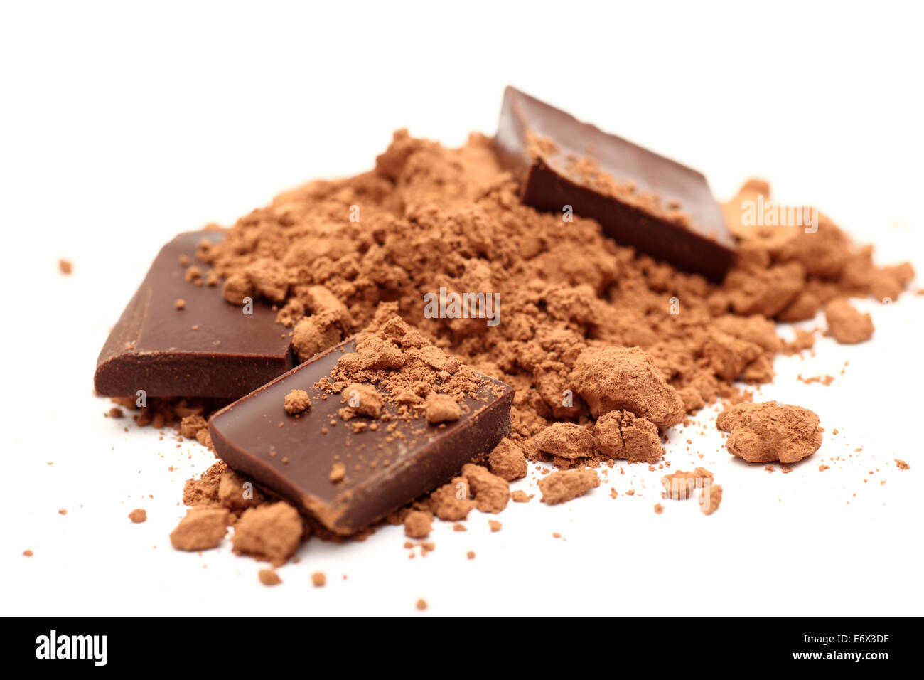 Pieces of chocolate in cocoa powder. SDOF. Closeup. Stock Photo