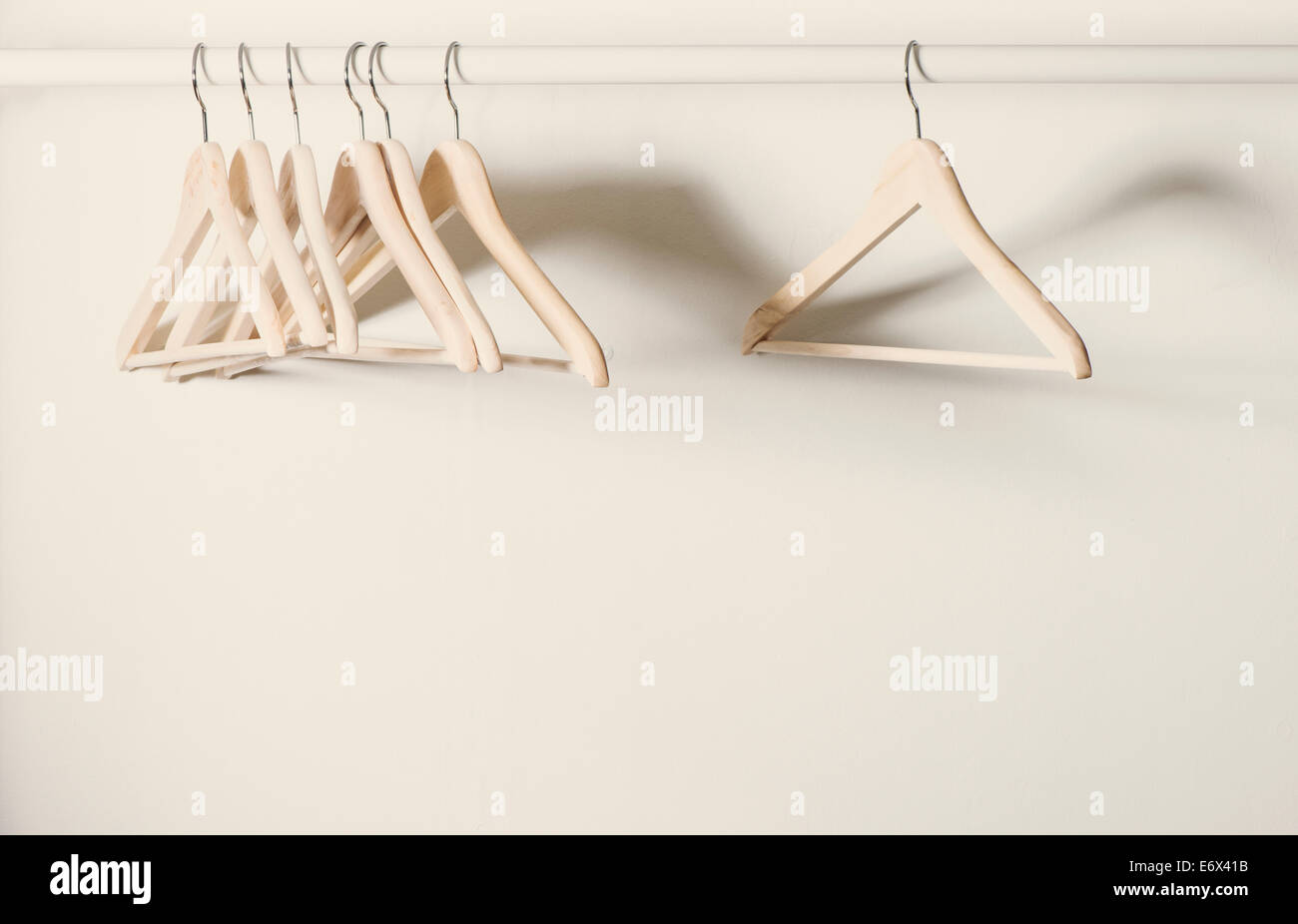 Empty hangers on a clothes rack in deserted cloakroom Stock Photo