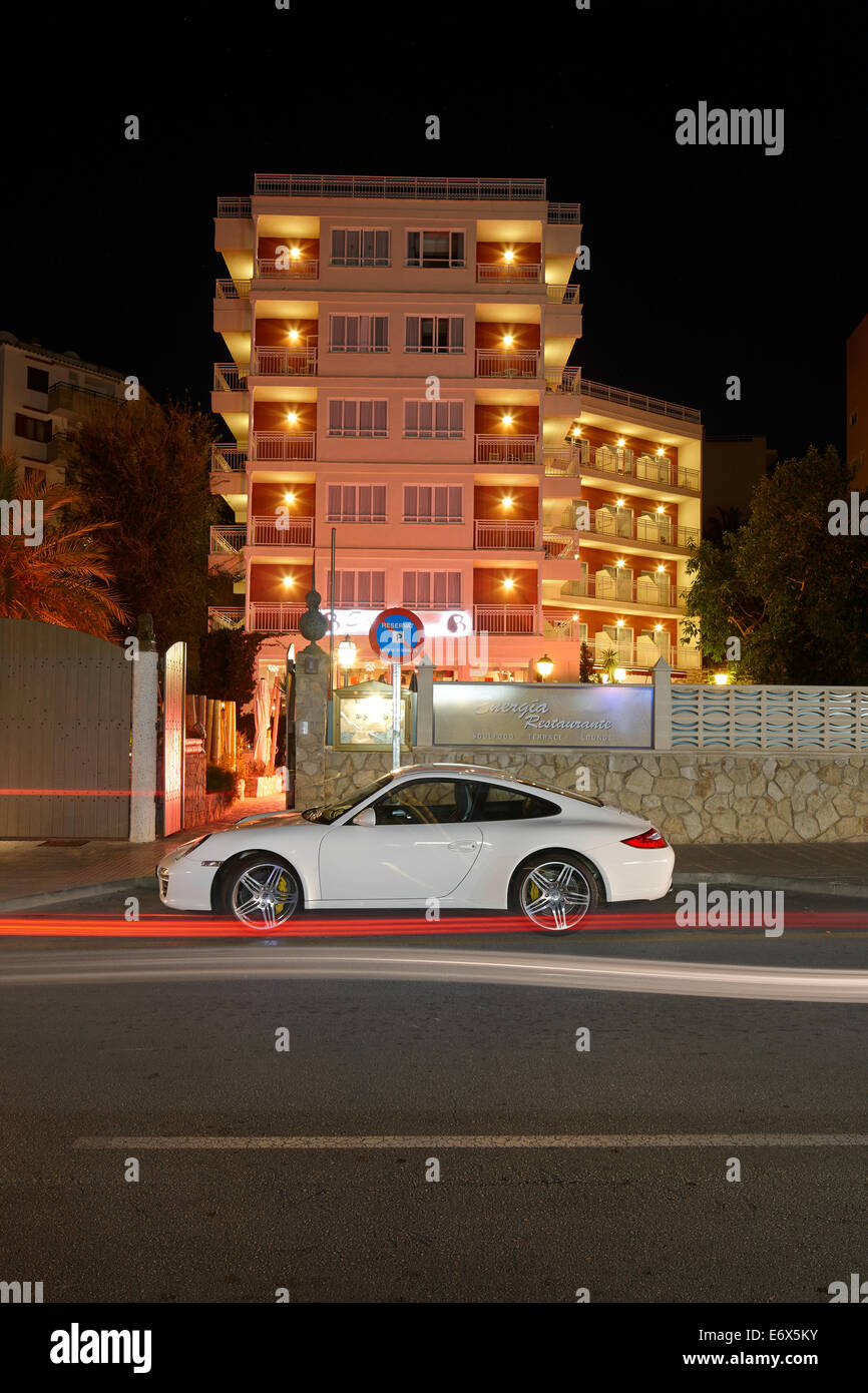 White Porsche at night in front of Energia Cocktail Bar and Lounge, Playas del Rey Boutique Hotel, Santa Ponsa, Mallorca, Balear Stock Photo